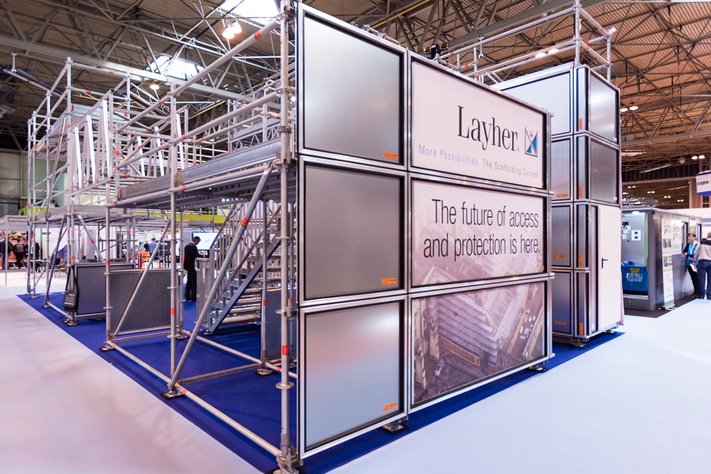 Layher exhibition scaffold at the NEC near Solihull with Protect Panel hoarding, secure access door and public access staircase