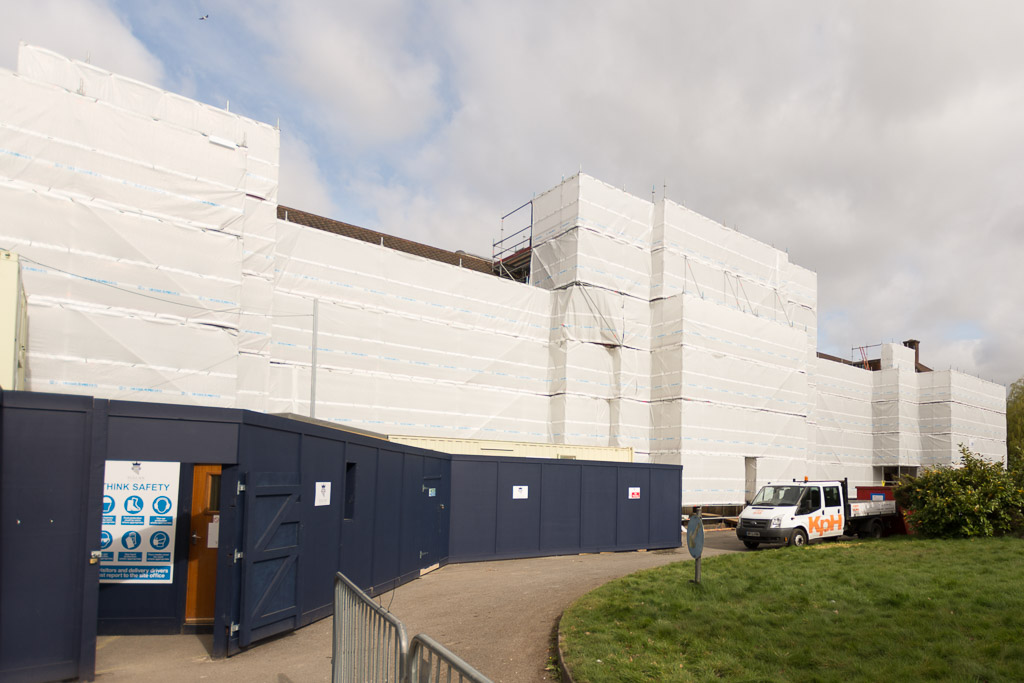 Independent scaffold fully sheeted constructed in Layher Allround scaffold, with painted blue hoarding