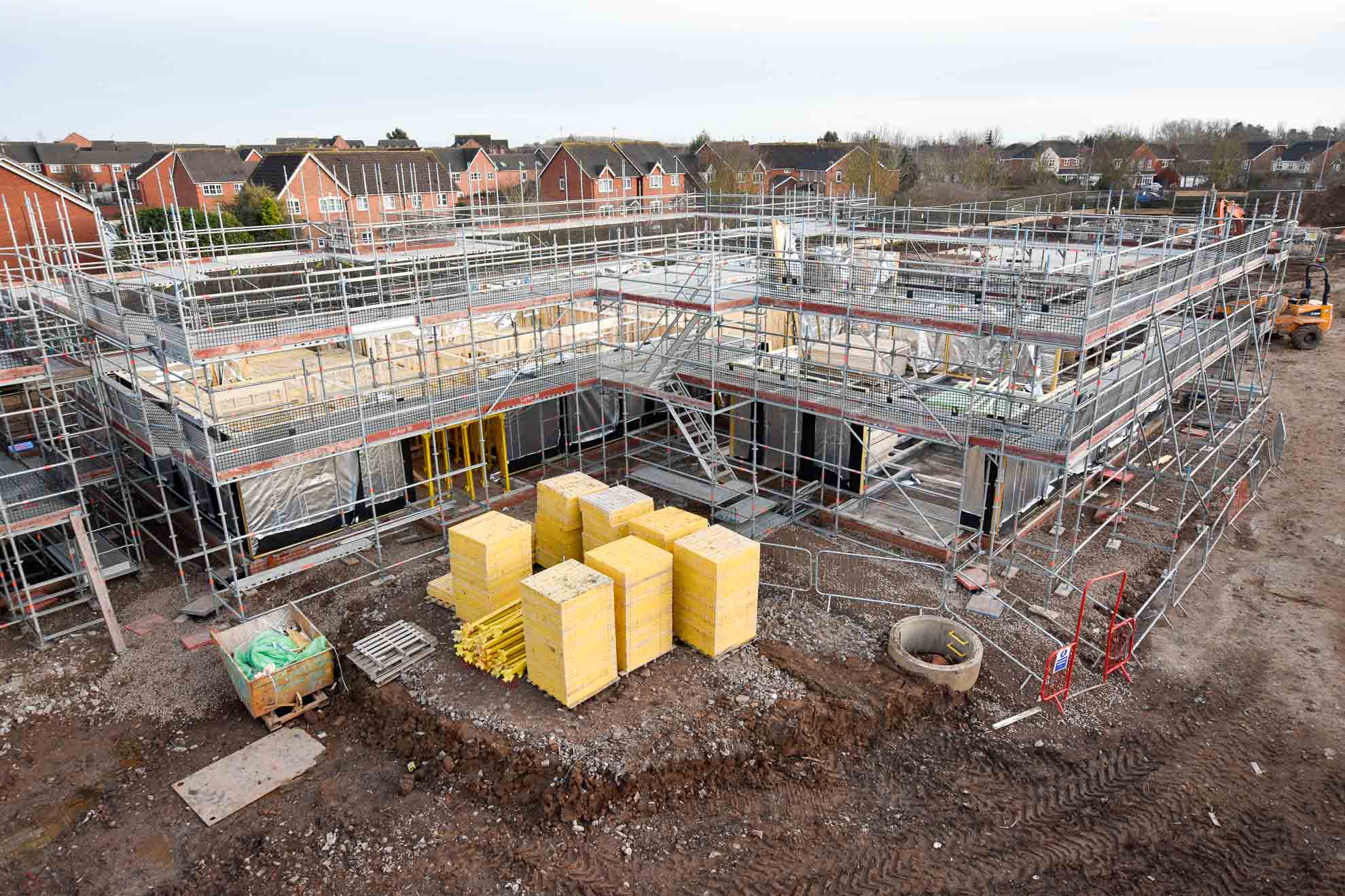 Buttressed scaffold for timber frame construction with site access staircase