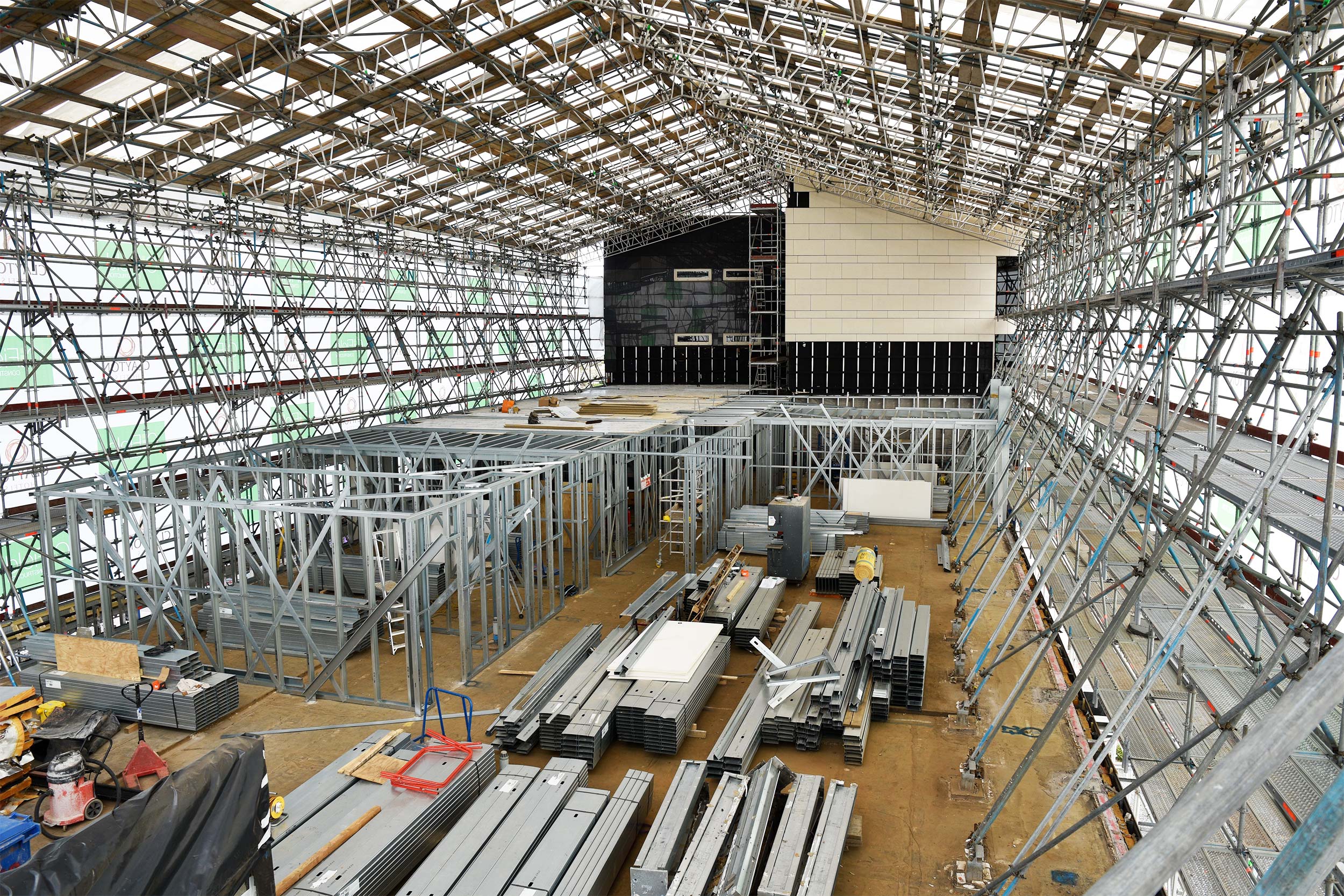 Internal view of a temporary roof scaffold for upper floor extension to a hotel in Birmingham. Scaffold erected in Layher Allround with HAKI roof, anchored to the existing roof slab via internal rakers.