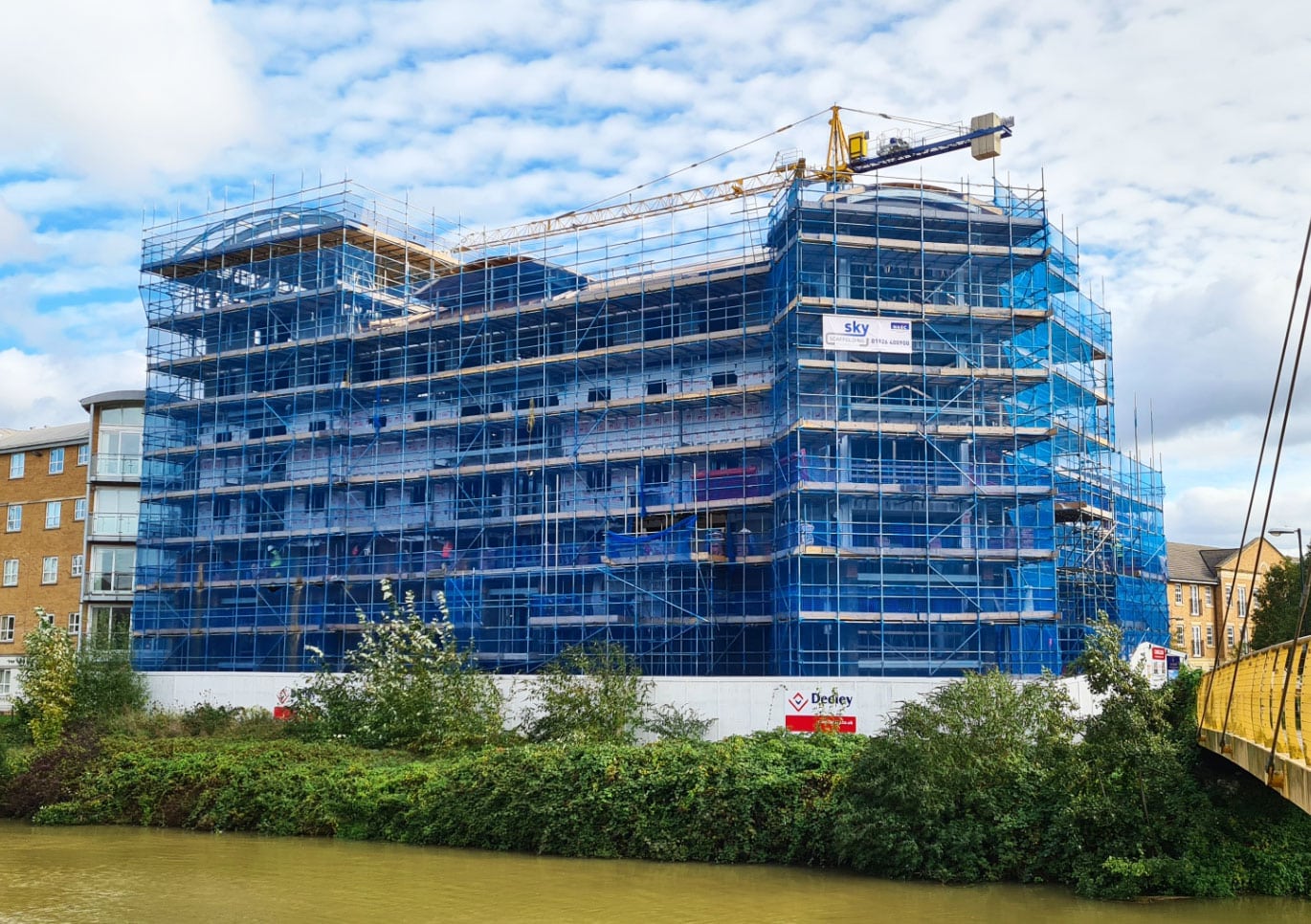 Fully boarded and netted tube and fitting scaffold for new build construction of apartment block in Northampton.