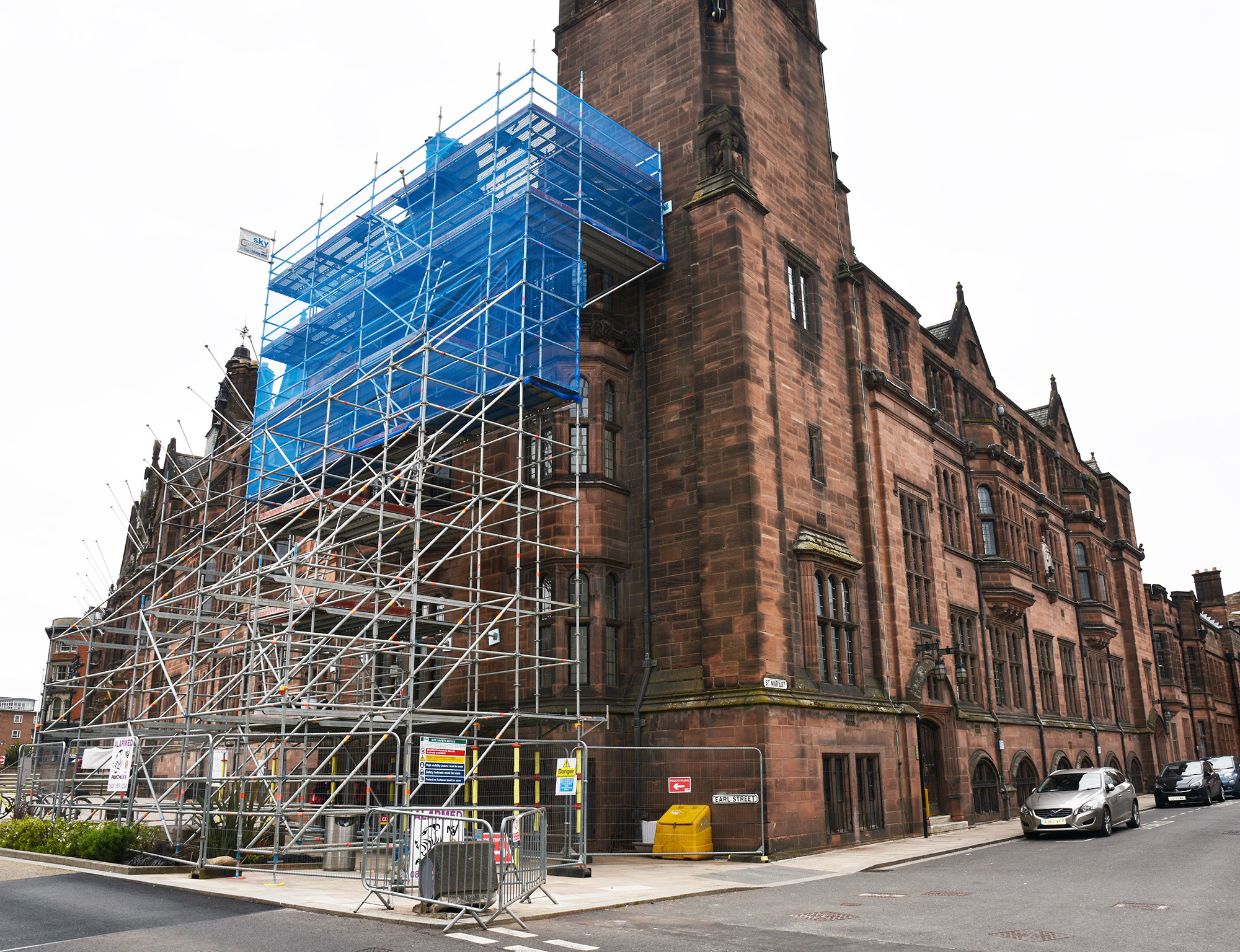 Buttressed access scaffold with netting on Coventry Council House.