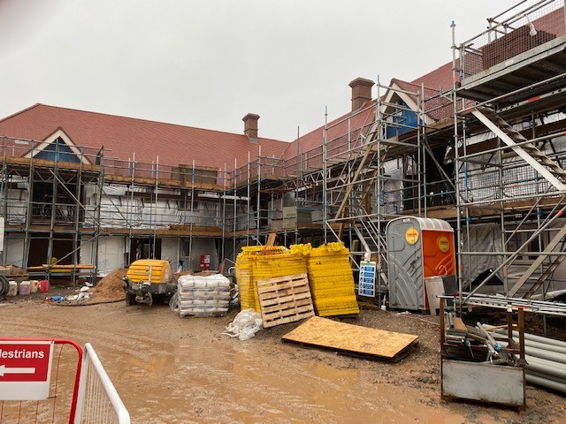 Tube and fitting scaffold on a timber frame building site with staircase access