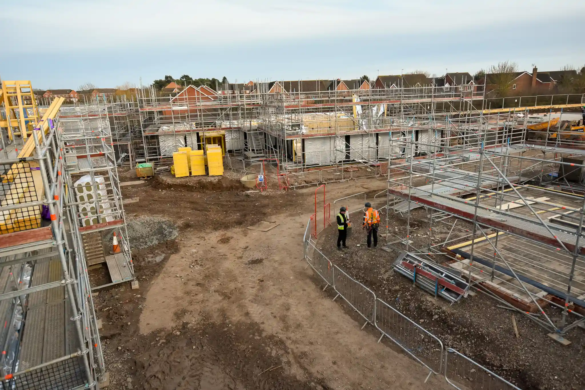 Timber frame construction site in Leamington Spa showing buildings with scaffold at various stages of completion